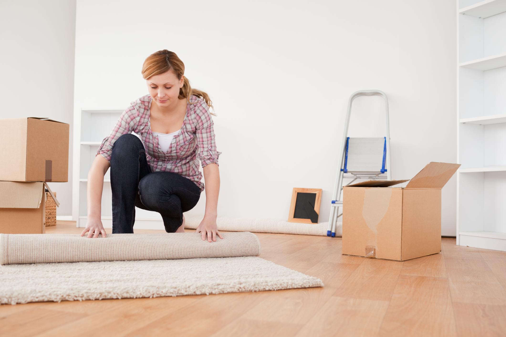 woman moving rug